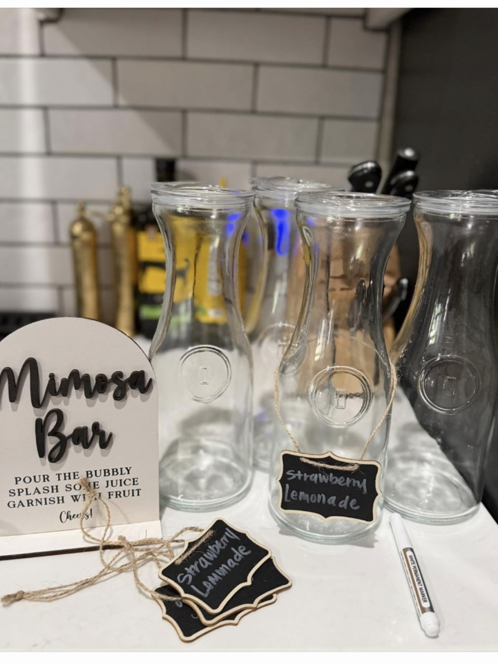 Clear Glass Carafes Set with Mimosa Bar Sign and Chalk Labels
